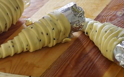 She Wraps Raw Dough Around A Tinfoil Cone. The End Result Is An Unexpected Yummy Surprise!