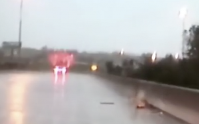 Cops Drive Over a Bridge During a Torrential Downpour. Then They Notice THIS On The Road!